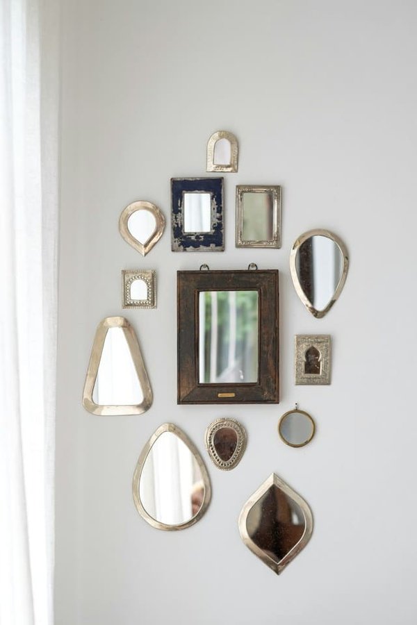 How can you use mirrors to enhance small spaces?